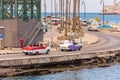 CUBA, HAVANA - MAY 5, 2017: American colorful retro cars traveling along the waterfront. Copy space for text.