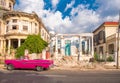 CUBA, HAVANA - MAY 5, 2017: American pink retro cabriolet on the background of buildings. Copy space for text.