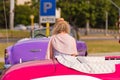 CUBA, HAVANA - MAY 5, 2017: Curly girl on the background of colored cars Cuba, Havana. Back view. Royalty Free Stock Photo