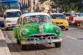 CUBA, HAVANA - MAY 5, 2017: A green American retro car on a city street. Copy space for text.