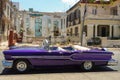 Cuba, Havana, Old Pontiac car in front of a ruined bourgeois house