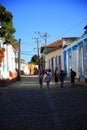 Cuba. Houses and people on a shady street in Trinidad