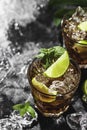 Cuba Libre with brown rum, cola, mint and lime. Cold Longdrink, alcohol cocktail. Royalty Free Stock Photo