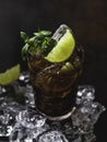 Cuba Libre with brown rum, cola, mint and lime. Cold Longdrink, alcohol cocktail. Royalty Free Stock Photo