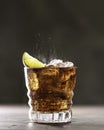 Cuba Libre with brown rum, cola, mint and lime. Cold Longdrink, alcohol cocktail. Place for text Royalty Free Stock Photo