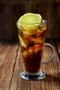 Cuba Libre coctail in a glass with ice and lime Royalty Free Stock Photo