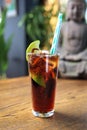 Cuba libre long drink. Cuban cocktail with rum, cola, lime and ice cubes, on a wooden table, selective focus. Royalty Free Stock Photo