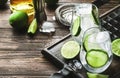 Cuba libre preparation alcohol cocktail with golden rum, lemon juice, cola, lime and ice, dark bar counter background, bar tools, Royalty Free Stock Photo