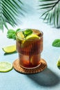 Cuba Libre with rum, cola, mint and lime in the glass on a light background, vertical image. top view. place for text Royalty Free Stock Photo