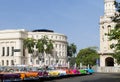 Cuba many classic cars parked in series in Havana with Capitol view Royalty Free Stock Photo