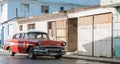 Cuba red american classic car parked in the countryside for a building Royalty Free Stock Photo