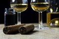 Cuban cigars, bottle and two glass of whiskey and lighter, on old wooden board