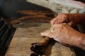 Cuban cigars crafter's hands rolling raw cigars