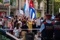 Cuban community protesting on the streets of Paseo de Gracia in front of the consulate embassy. Rally, flags and cartels against