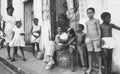A cuban family sitting outside of the house on the street in La Habana