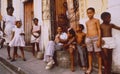 A cuban family sitting outside of the house on the street in La Habana vieja
