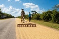 Cuban farmer raises rice to dry it on the road