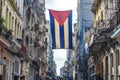 A Cuban flag hangs proudly from a balcony in the streets of Central Havana Royalty Free Stock Photo