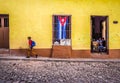 Cobblestone street in trinidad with cuban flag