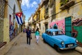 Cuban flags, old car and colorful buildings in Old Havana Royalty Free Stock Photo