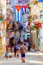 Cuban flags, people and aged buildings in Old Havana Royalty Free Stock Photo