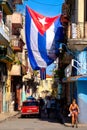 Cuban flags, people and aged buildings in Old Havana Royalty Free Stock Photo