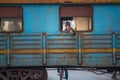 A Cuban friendly lady say hello in a colorful train from Caribbean colonial town railway, Trinidad, communism Cuba, America