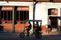 Cuban lady is traveling in an traditional bici-taxi in Old Havana