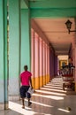 Cuban man walking through colorful passway in Havana