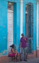 Mother and child sitting in street of Caribbean communism Cuba, America