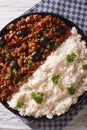 Cuban Picadillo a la habanera with rice close-up. vertical top v