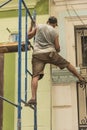 Cuban worker balancing on scaffold Havana