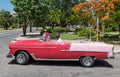 Cubans drives in your red american Oldtimer in Varadero