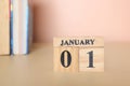 Cube calendar with date January 1st and books on the table.start new year 2024 Royalty Free Stock Photo