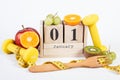 Cube calendar, fruits, dumbbells and centimeter, new years resolutions Royalty Free Stock Photo