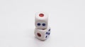 The cube is on the cube. Heap of white cubic dice with blue and red spikes dots on a white background. Royalty Free Stock Photo