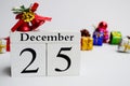 Cube Date 25th December with blurred christmas ornament background