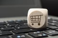 Cube dice on a keyboard with a cart, online shopping