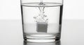 A cube of effervescent tablet dissolving in a glass of water Royalty Free Stock Photo