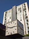 Cube Saped Clock and Modern Apartment Building