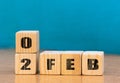 Cube shape calendar for February 02 on wooden surface with empty space for text,cube calendar for december on wood background Royalty Free Stock Photo