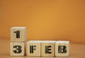 Cube shape calendar for february 13 on wooden surface with empty space for text, new year Wooden calendar with date, February cube Royalty Free Stock Photo