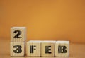 Cube shape calendar for february 23 on wooden surface with empty space for text, new year Wooden calendar with date, February cube Royalty Free Stock Photo