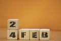 Cube shape calendar for february 24 on wooden surface with empty space for text, new year Wooden calendar with date, February cube Royalty Free Stock Photo