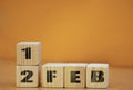Cube shape calendar for february 12 on wooden surface with empty space for text, new year Wooden calendar with date, February cube Royalty Free Stock Photo