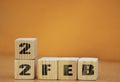 Cube shape calendar for february 22 on wooden surface with empty space for text, new year Wooden calendar with date, February cube Royalty Free Stock Photo