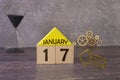 Cube shape calendar for January 17 on wooden surface with empty space for text,