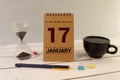 Cube shape calendar for January 17 on wooden surface with empty space for text,