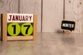 Cube shape calendar for January 17 on wooden surface with empty space for text,