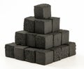 Cube shaped coal briquettes made from coconuts. Isolated on white background. Stack of coal briquettes.